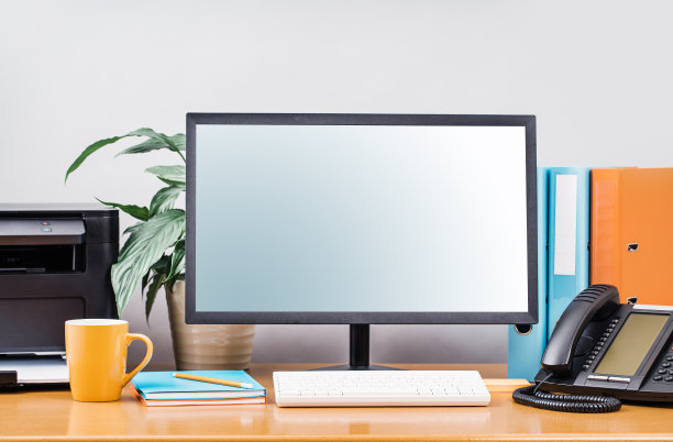 带模型显示器屏幕、用品和IP电话的传统办公桌图片下载