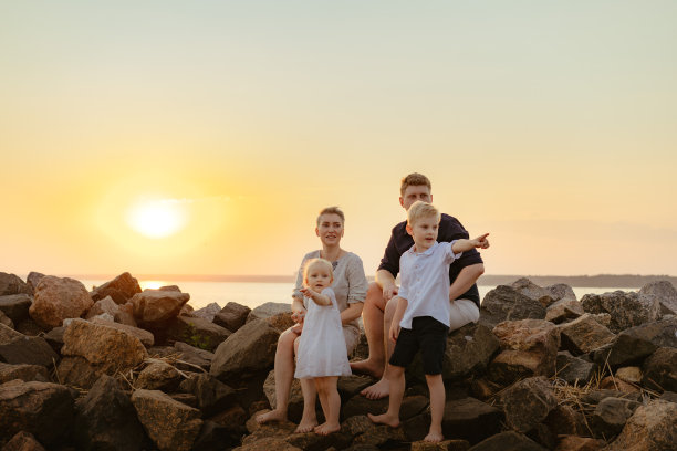 可爱的白人家庭与母亲期待孩子享受海滩日落。高质量的照片图片下载