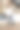 穿着白衬衫和牛仔裤的年轻美女，光着脚，手里拿着笔记本电脑，站在现代厨房的背景下。厨房家具制造。在家上网工作。图片下载