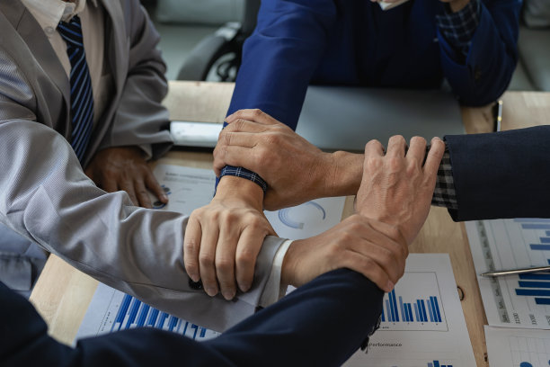 大型的商业团队用他们的手团结在一起，一群男女商人在办公室里手拉手表达为项目的成功而工作的喜悦。远程图片图片下载