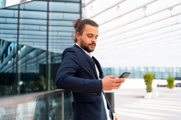 站在户外的商人使用智能手机图片下载