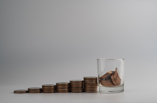 硬币装在一个白色背景的小罐子里图片下载