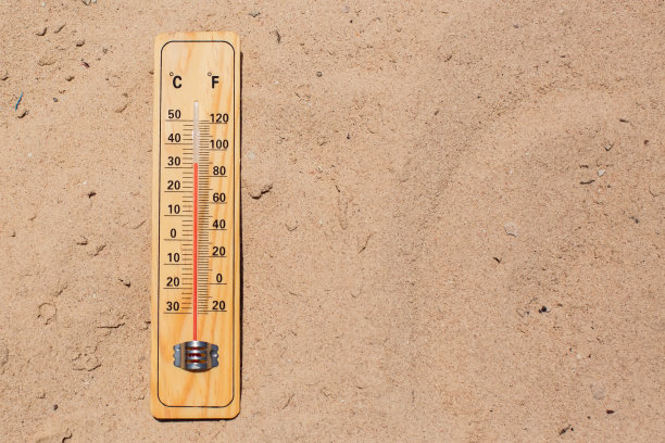沙子上的温度计显示高温。炎热天气和气候概念图片下载
