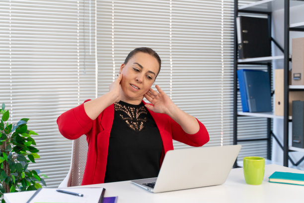 在办公室工作时做伸展运动的女人图片下载