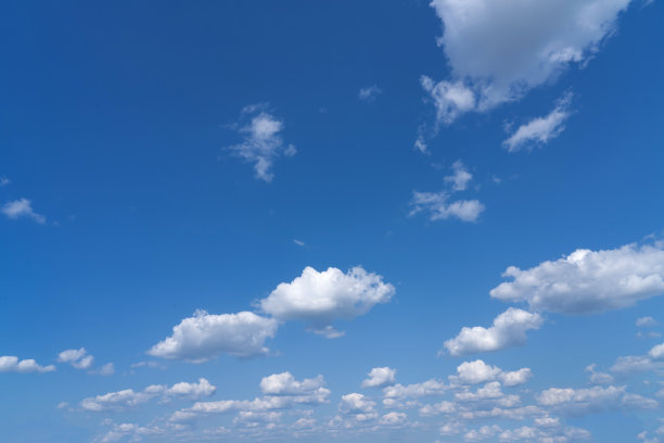 白色蓬松的云朵在黑色的背景和蓝色的天空下显得格外显眼图片下载