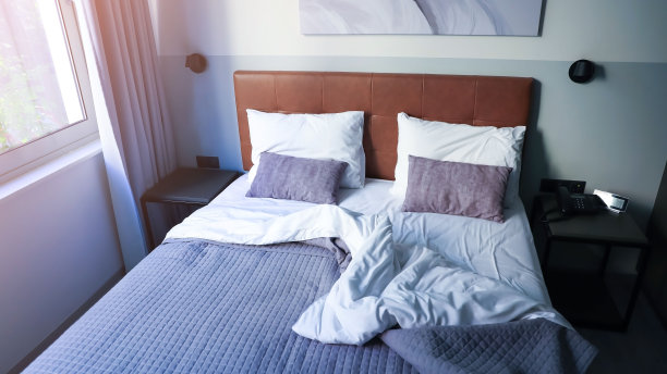 白色的靠垫和白色的枕头作为现代卧室内部与时髦的房间内部形象的结合图片下载