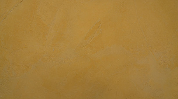 墙面纹理呈黄色，表面为旧水泥墙面。特写镜头图片下载