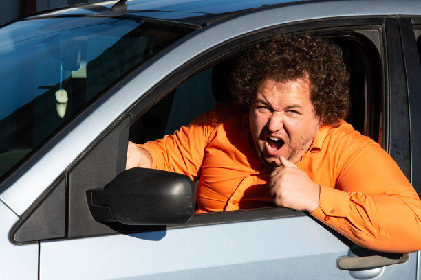 一个愤怒而不满的司机在严重的交通堵塞中匆忙回家。图片下载