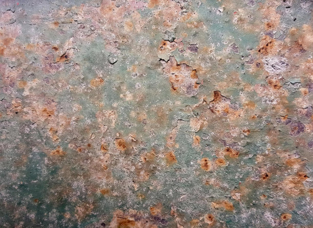 一张带有一些铁锈的生锈表面和一些绿色的生锈金属表面的照片，上面有铁锈和油漆。图片下载