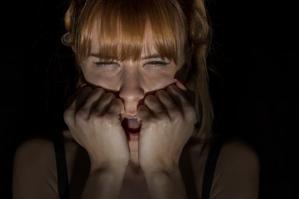 一个在黑暗中害怕的女人的画像。闭上眼睛图片下载