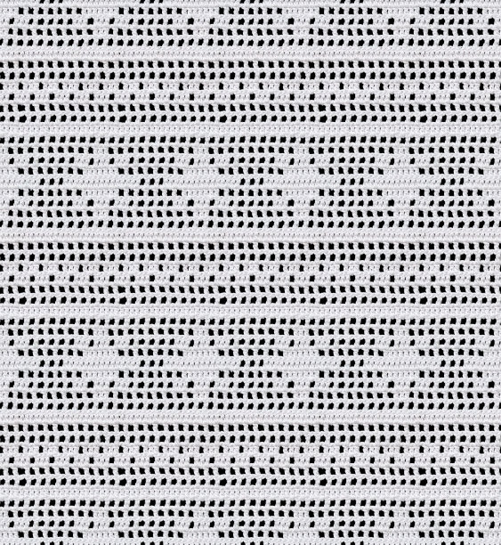 白雪无缝针织质感。菲力花边的形式，在雪花钩针图案。棉纱。图片下载