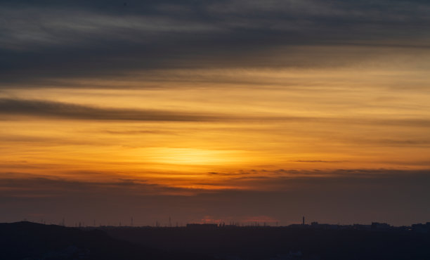 黄昏时城市的剪影。动态的云。图片下载