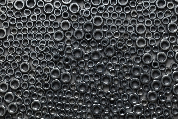 各种尺寸的金属螺母紧固件背景。图片下载