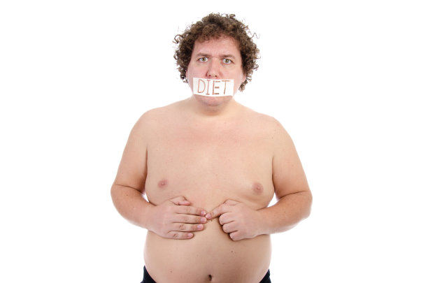 饮食和营养不良。滑稽的胖子在摄影棚里摆姿势。图片下载