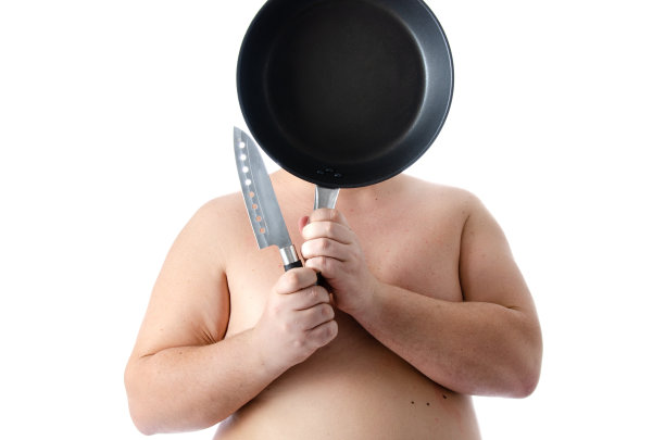 饮食和营养不良。滑稽的胖子在摄影棚里摆姿势。图片下载