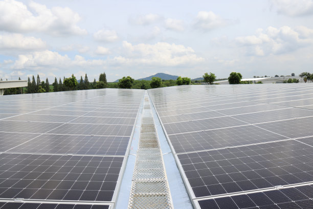 俯瞰安装在工业建筑屋顶上的黑色光伏太阳能板图片下载