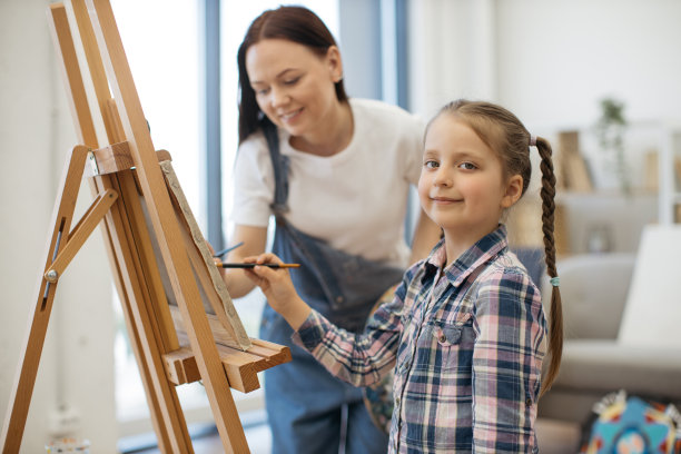 女艺术家通过引导她的手教女孩有趣的形状图片下载