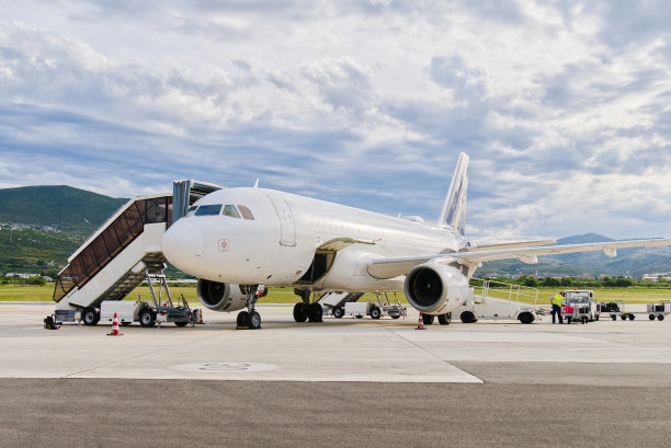 飞机停在机场。机场工作人员正在为飞机的起飞做准备图片下载