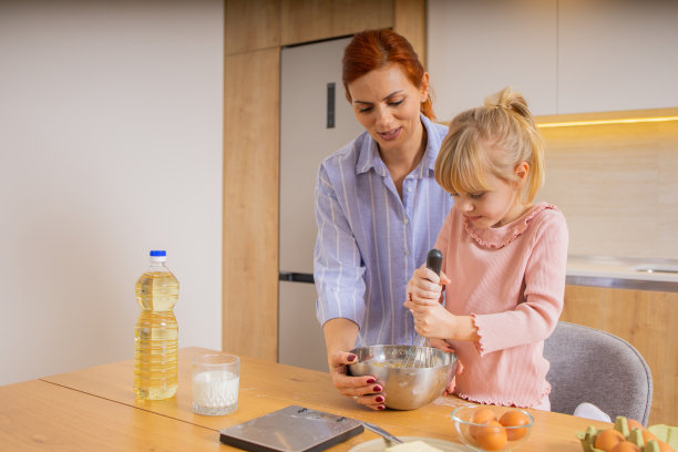 一张母亲和女儿在厨房里烤面包的照片图片下载