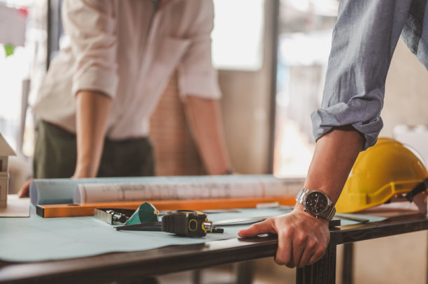 工程师手拉手在桌子上开会，头脑风暴，准备蓝图架构师建造项目。图片下载
