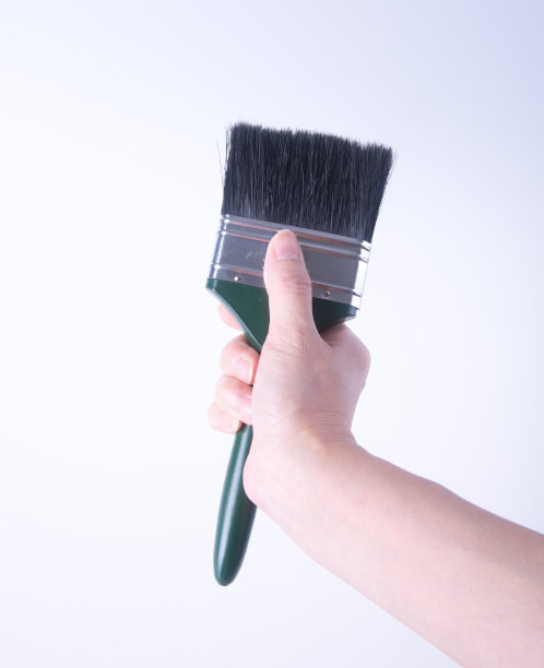 用手刷油漆。用手在背景上刷漆图片下载