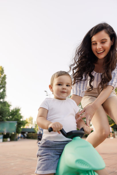 母亲扶着儿子骑自行车图片下载