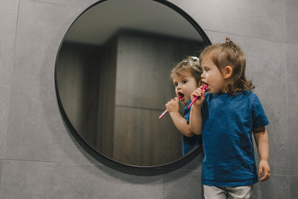 小女孩穿着睡衣在浴室刷牙准备睡觉。卫生保健。口腔卫生图片下载