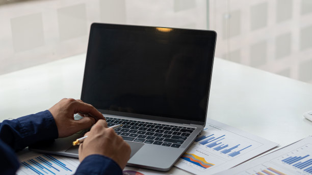 商人使用计算器与笔记本电脑，预算和贷款纸，财务审计师和秘书做一个余额计算报告。税务局检查这些文件。图片下载