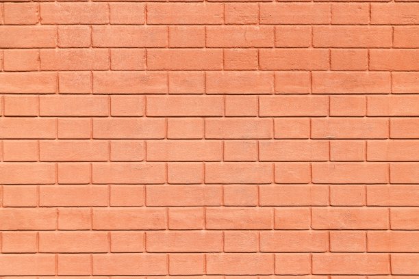 砖墙的纹理，涂上厚厚的淡黄色涂料作为建筑背景图片下载