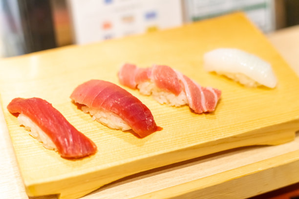 日本厨师准备章鱼寿司，将其放在木板上给顾客图片下载