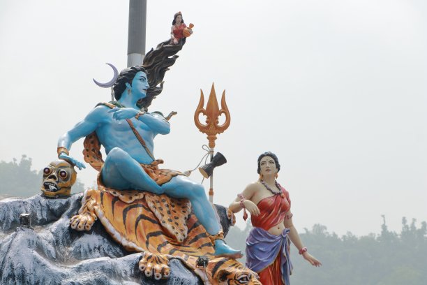 湿婆神和帕瓦蒂的巨大雕像，湿婆神坐在老虎背上，女神恒河坐在她的头发上，不同角度和焦点的照片。图片下载