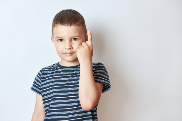 小男孩用食指举起他的手。注意和谨慎的概念。图片下载