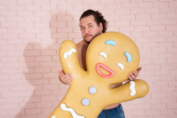 滑稽的胖子梦见甜甜圈和蛋糕。图片下载