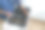 穿着制服的专业杂工手持打开的工具箱坐在厨房地板上的特写图片下载