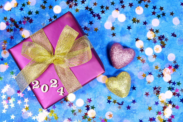 新年贺卡上有明亮的灯光，礼盒和心形闪闪发光的玩具，蓝色垃圾背景上有星星五彩纸屑图片下载