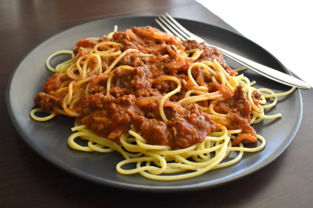 用叉子盛在盘子里的意大利肉酱面。图片下载