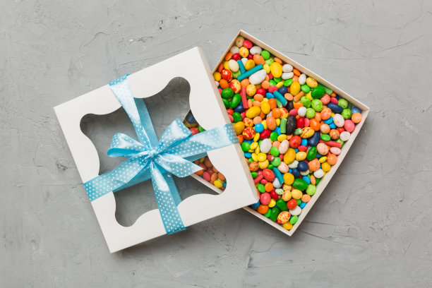 盒装巧克力糖果，彩色背景，各种糖果。情人节礼盒。顶视图平面布局与复制空间图片下载