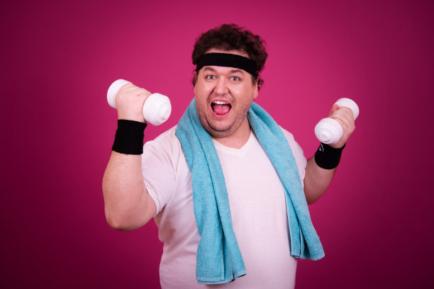 滑稽的胖子正在健身，并且贪婪地吃了一个汉堡包。复古的风格。图片下载