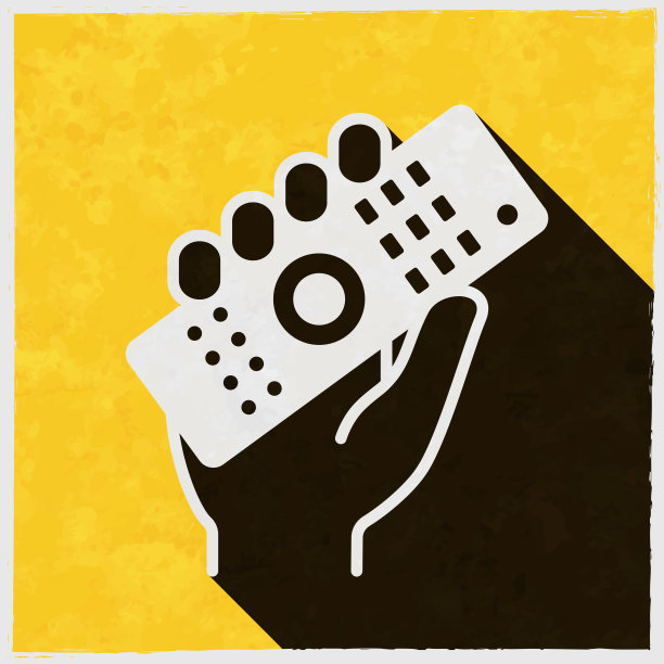 手拿遥控器。图标与长阴影的纹理黄色背景图片下载