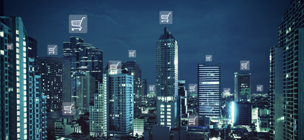 网上购物主题与模糊的城市景观在日落或日出图片下载