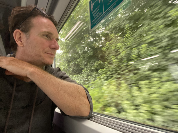 一名男子向火车窗外望去图片下载