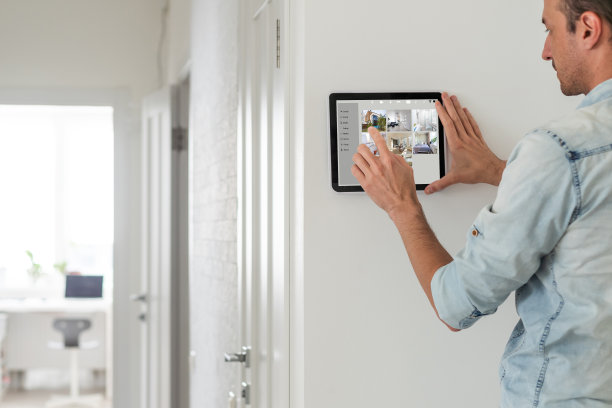 人用平板面板应用程序控制智能家居生活。金发女触摸无线设备控制器，用于家庭自动化在墙上图片下载