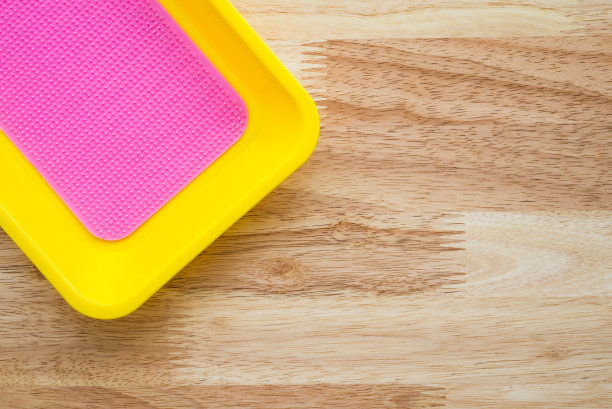 木桌上空空的彩色硬币盘。图片下载