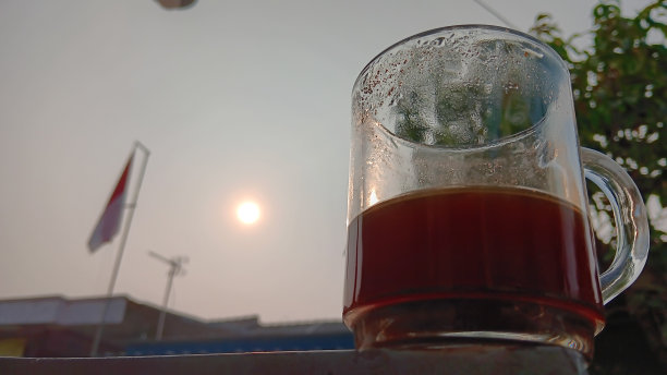 一杯黑咖啡，一面红白相间的旗帜，还有清晨的阳光图片下载