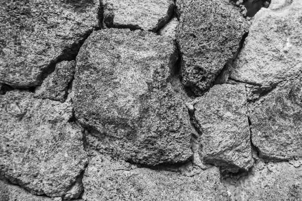 一种铺路砌块的纹理，混凝土砌块。古老的城堡石墙。图案为灰色，颜色为现代风格设计，装饰凹凸有致的真石墙面用水泥。砖纹理壁纸或背景。图片下载