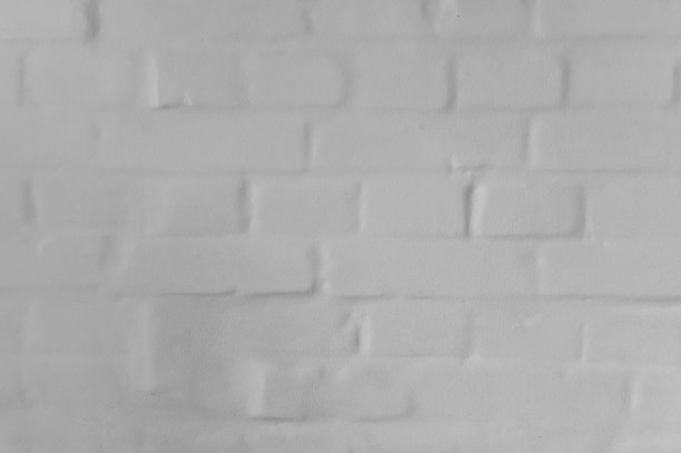 白色纹理的砖墙被抹灰了。无缝的背景图片下载