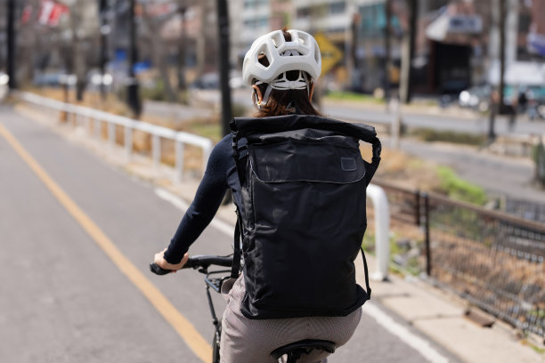 天气好的时候，一个亚洲女人骑着自行车去上班图片下载