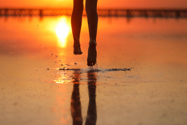 暑假积极旅游。腿部剪影能量小女孩，男孩在日落时在海滩上跑步和玩耍。青春，生活方式，幸福理念。儿童节图片下载