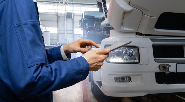 卡车背景上手持平板电脑的维修人员图片下载