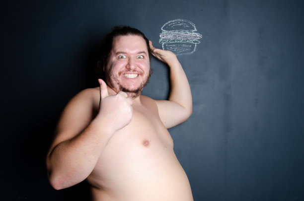 饮食和健康的生活方式。吃汉堡的滑稽胖子。图片下载